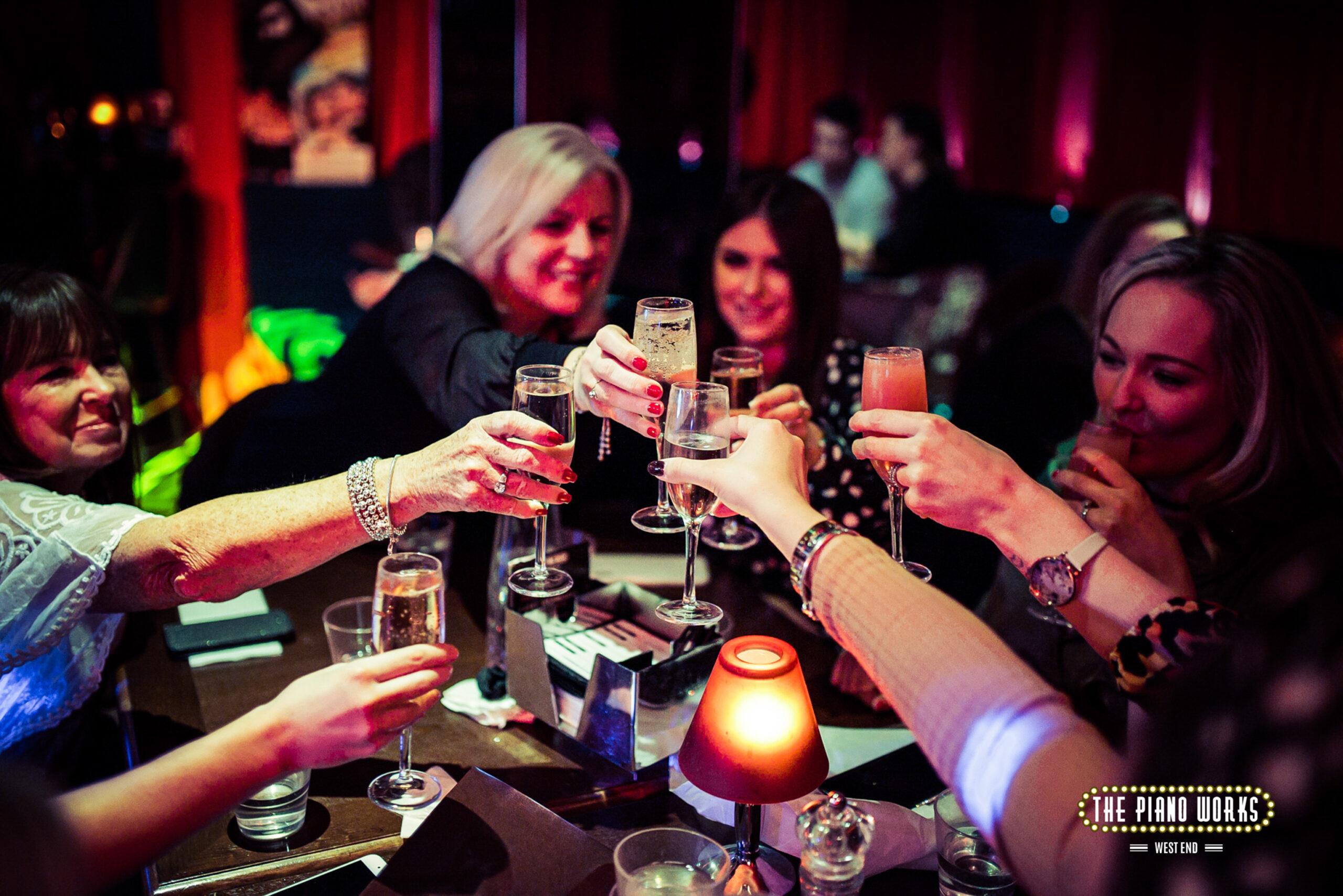 customers toasting each other with glasses of prosecco at The Piano Works