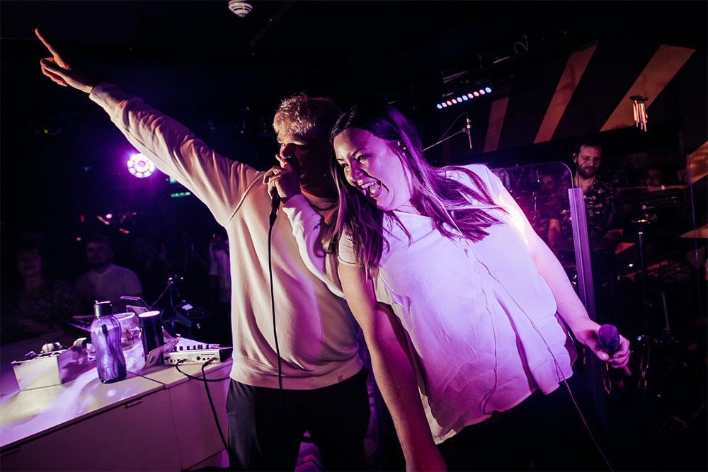 Customer on stage with singer at The Piano Works